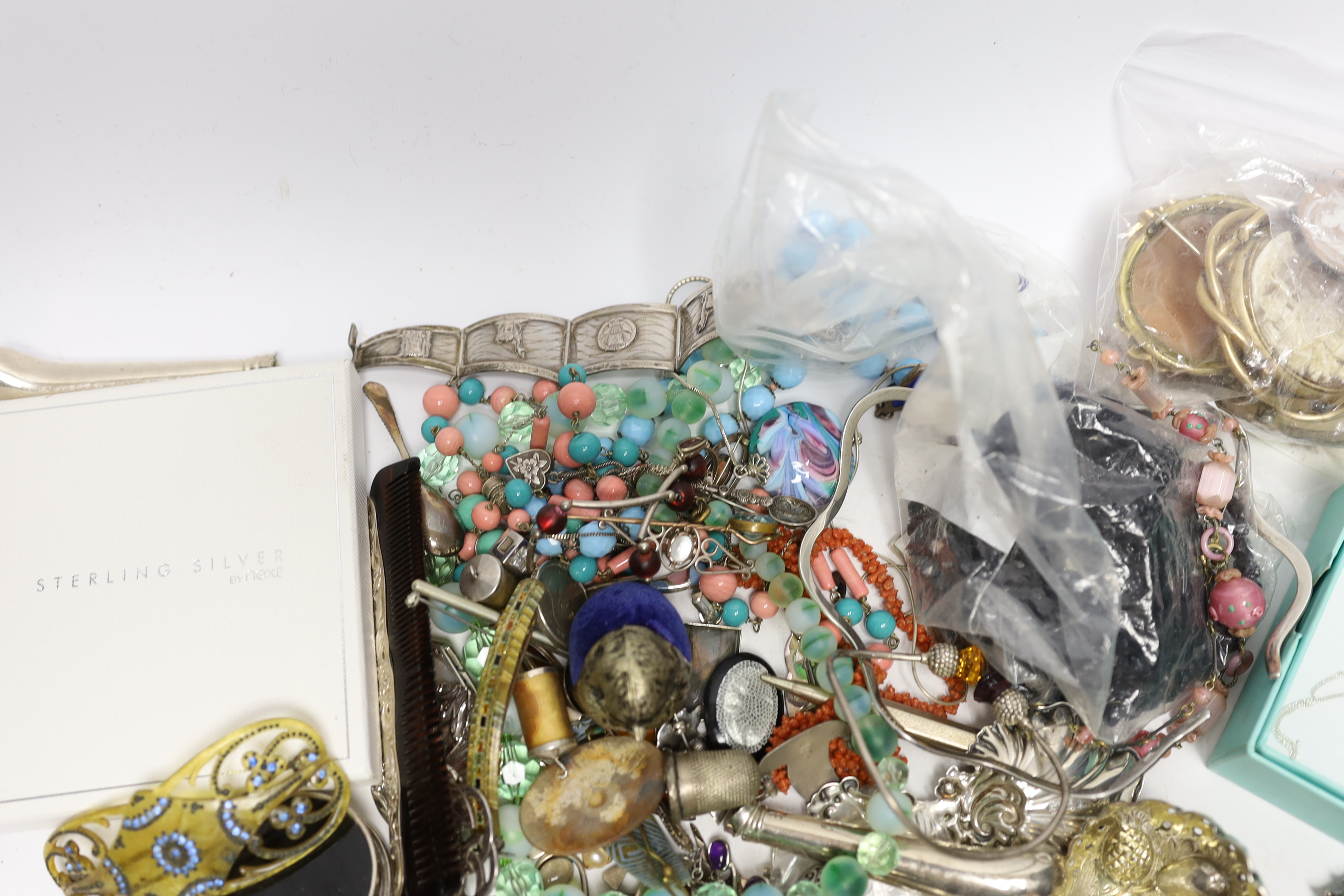 A quantity of assorted costume and other jewellery including a Charles Horner white metal and gem set brooch and sundry silver including two 19th century caddy spoons and a Georgian sifter spoon.